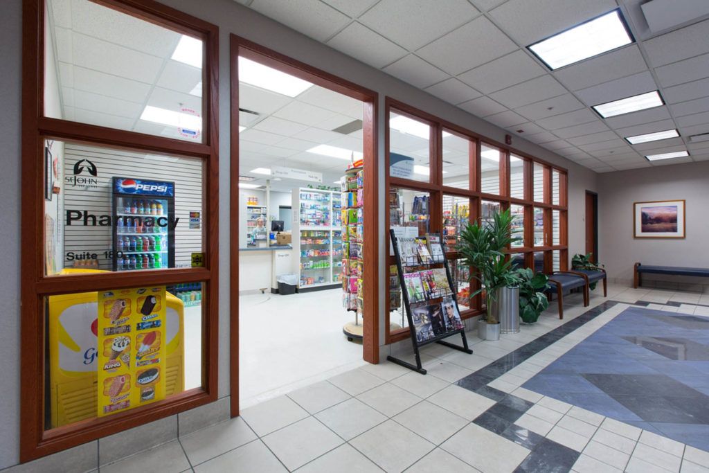 Interior view of a pharmacy with glass windows and well-organized shelves.