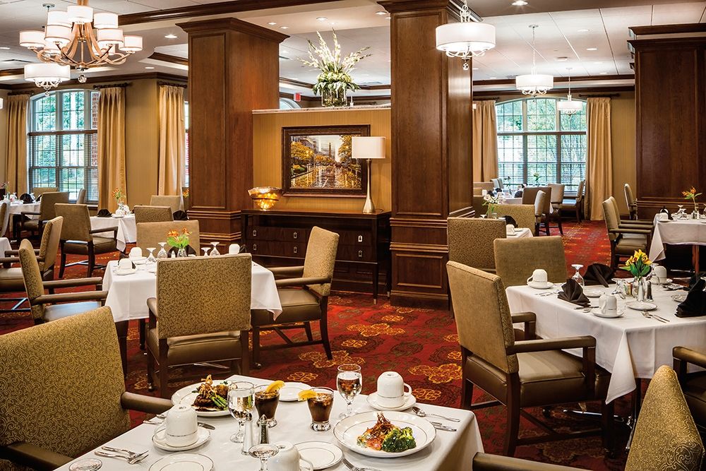 A sophisticated restaurant dining area with neatly arranged tables and elegant interior decor.