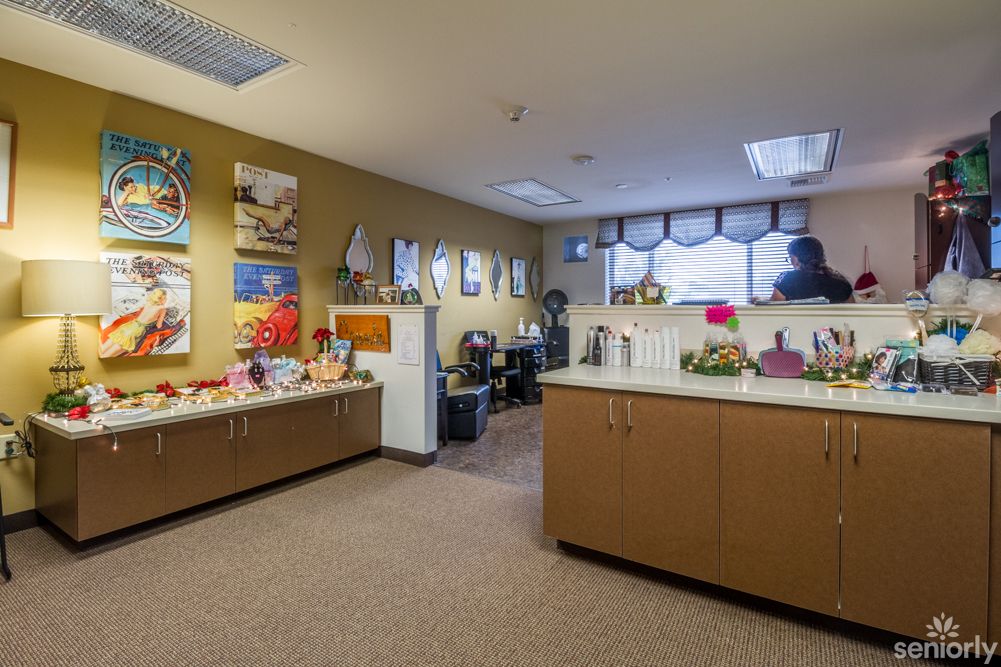 A well-decorated office space featuring artwork and tidy furnishings.