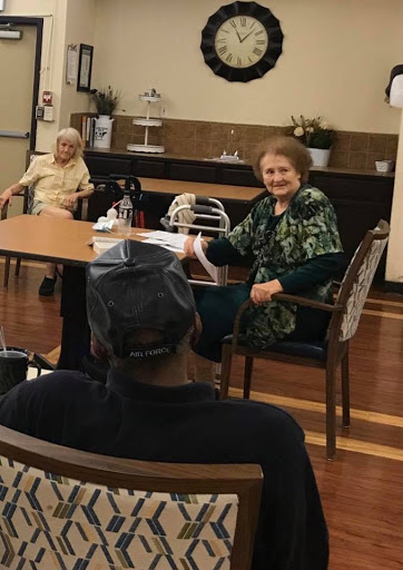 A lively conversation among seniors at a community center.