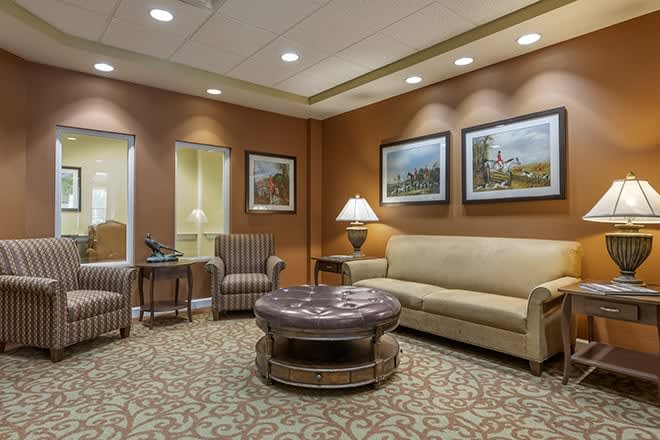 A cozy lobby or waiting room with comfortable seating and warm lighting.