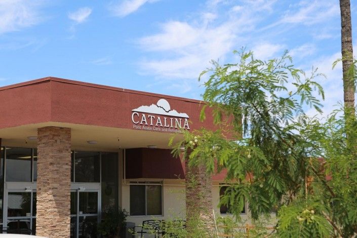 A building with the sign 'Catalina' surrounded by trees under a blue sky.