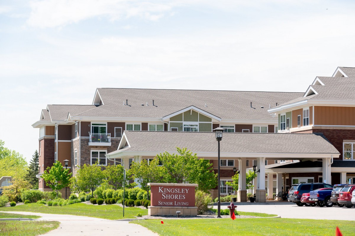 A retirement community building with a landscaped entrance.