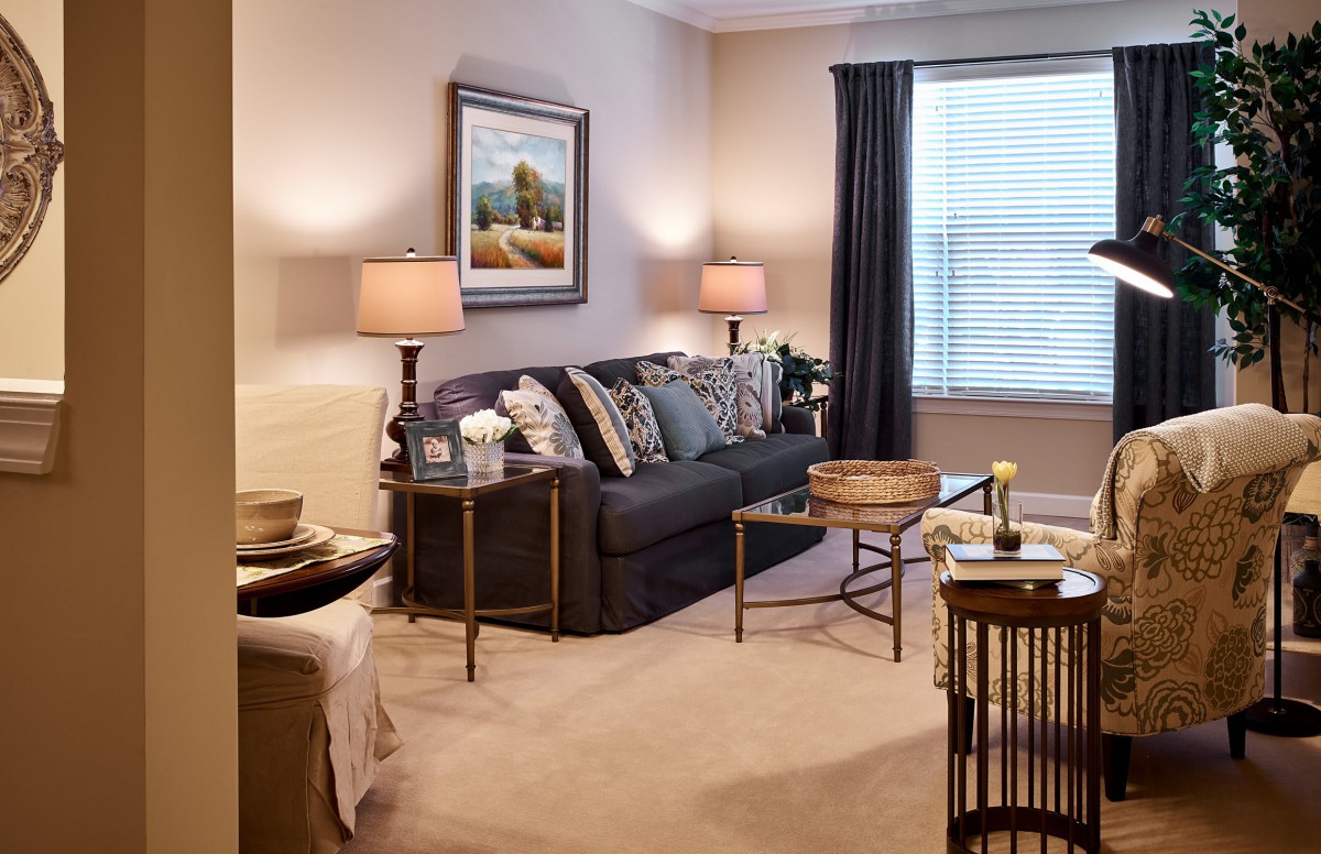 A cozy living room with a sofa, stylish lamps, and elegant decor.