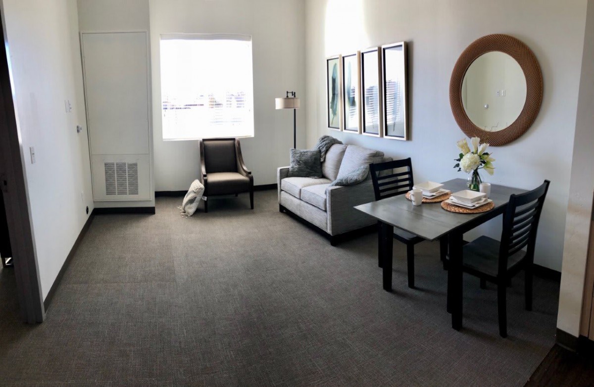 A minimalist living room with a sofa, table, and chair.