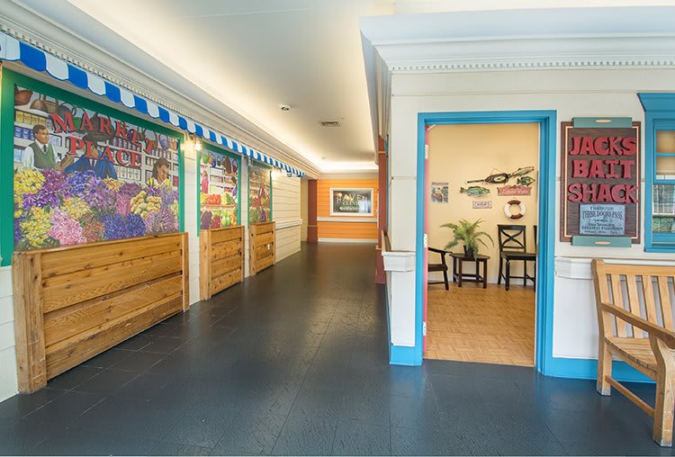 A colorful hallway with vibrant artwork leading to an office space.
