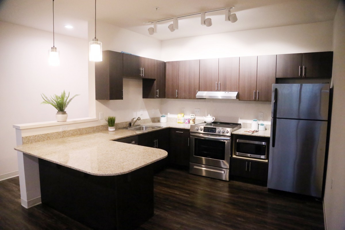 A modern kitchen with sleek cabinetry and stainless steel appliances.