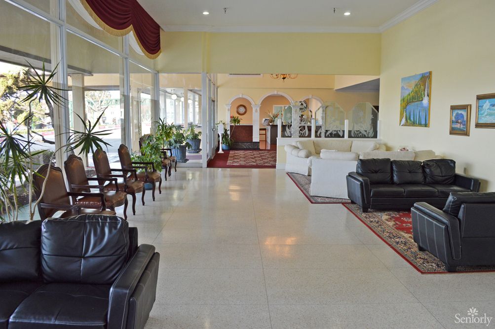 A spacious and elegantly designed lobby with comfortable seating and indoor plants.