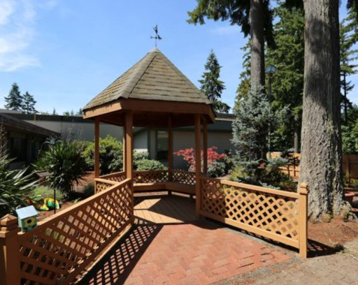 A charming gazebo nestled in a beautifully landscaped garden, inviting relaxation on a sunny day.
