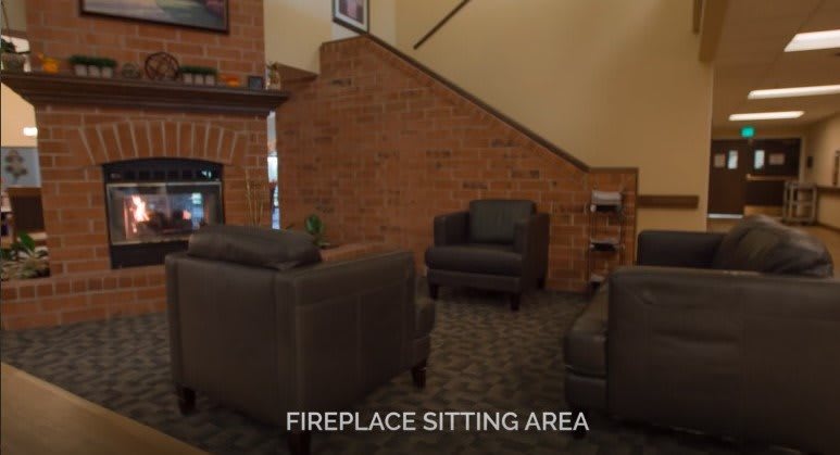Cozy fireplace sitting area with comfortable chairs.