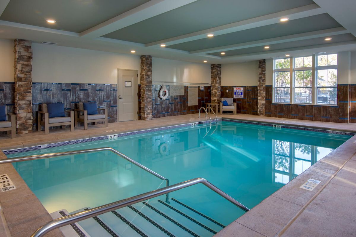 A tranquil indoor swimming pool area in a hotel setting.
