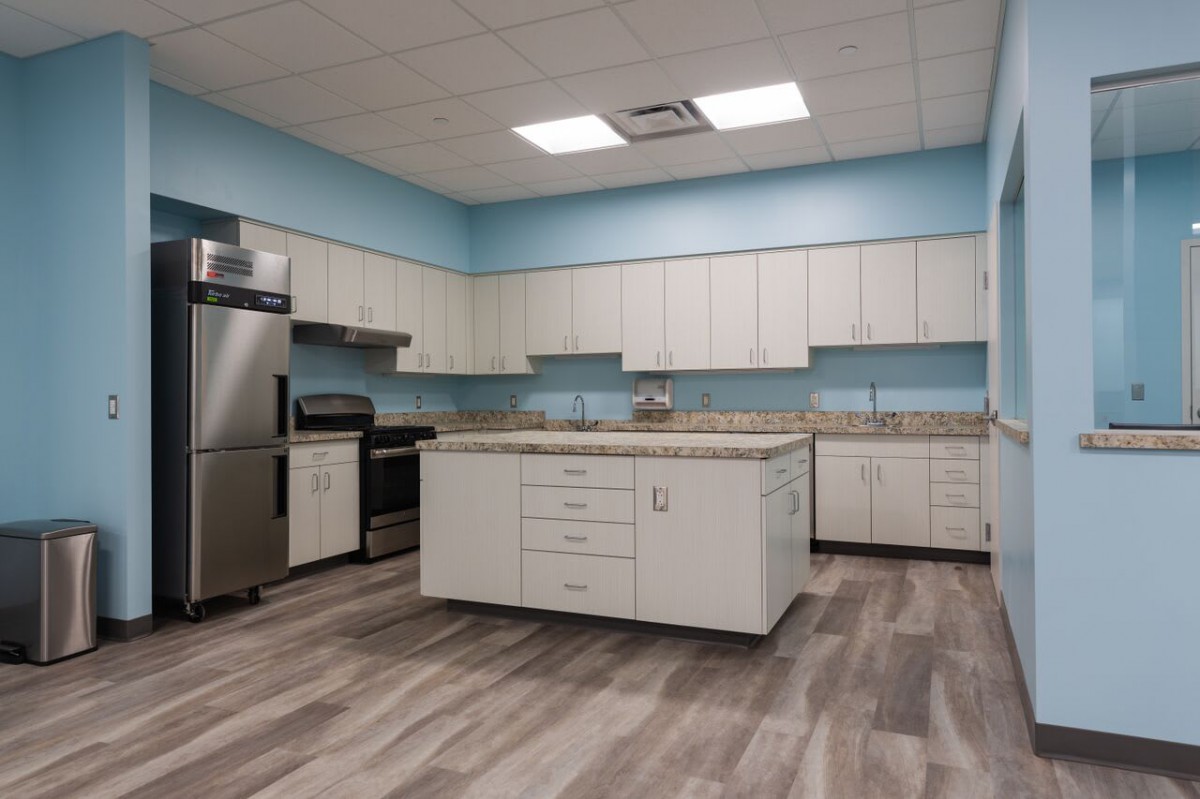 A modern kitchen with an island and stainless steel appliances.