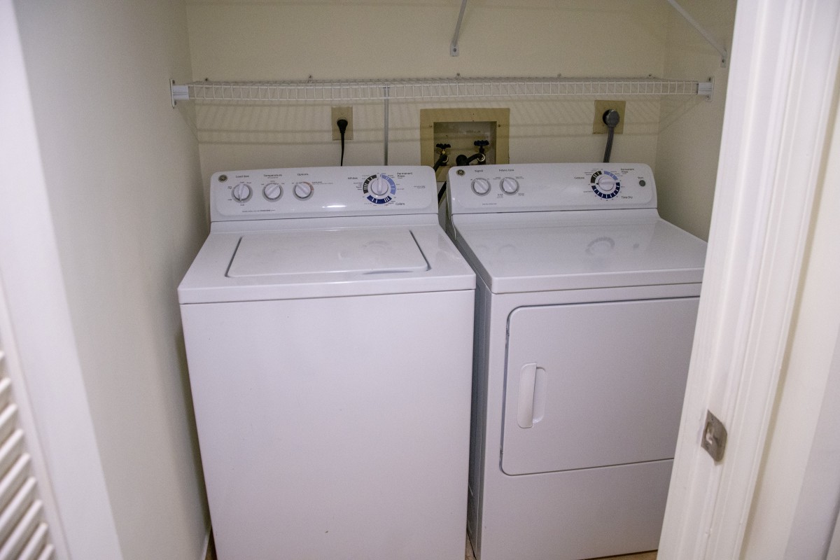 A compact laundry area featuring a washer and dryer set.