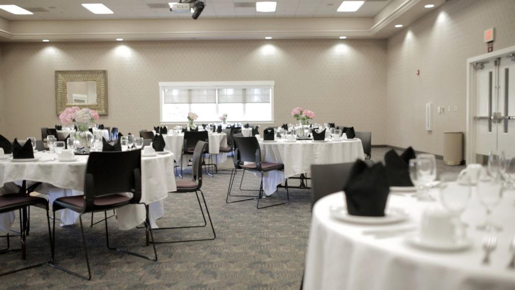 A formal banquet hall with tables set for an event.