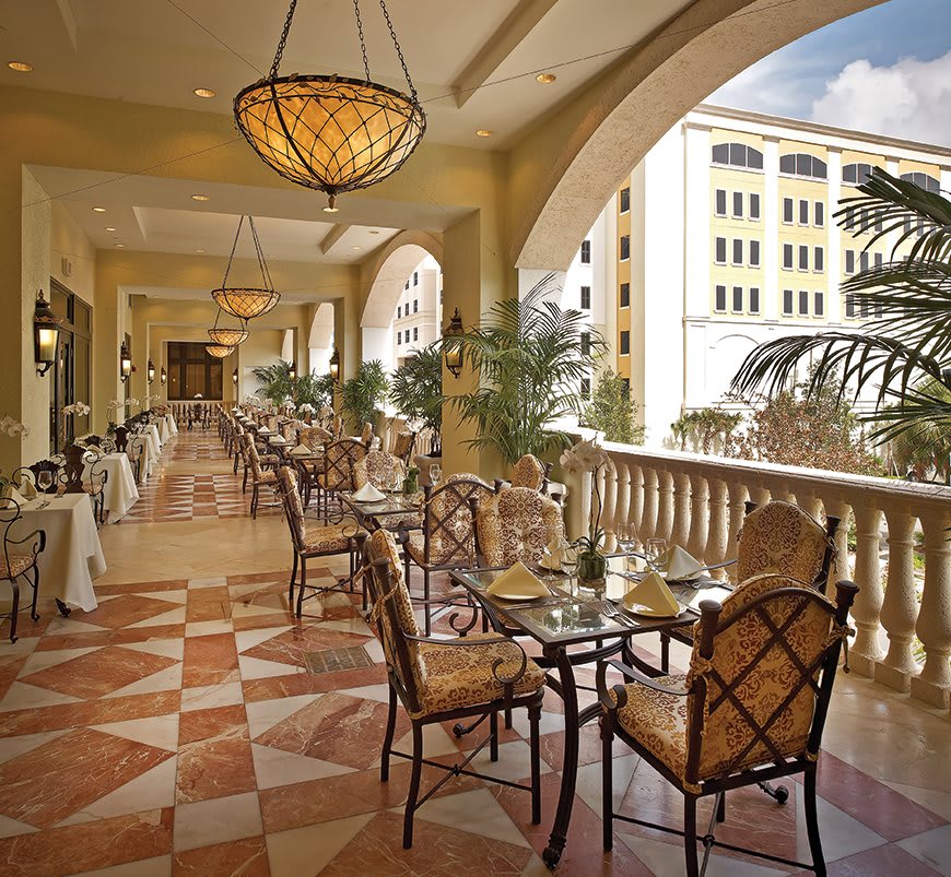 Elegant restaurant balcony with outdoor seating.
