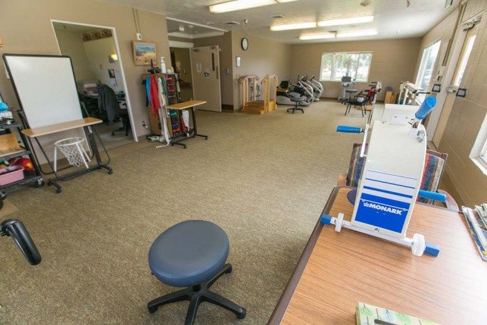 A spacious exercise room with various fitness equipment and training tools.