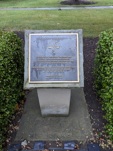 A memorial plaque set in a landscaped area, commemorating an important event or individual.