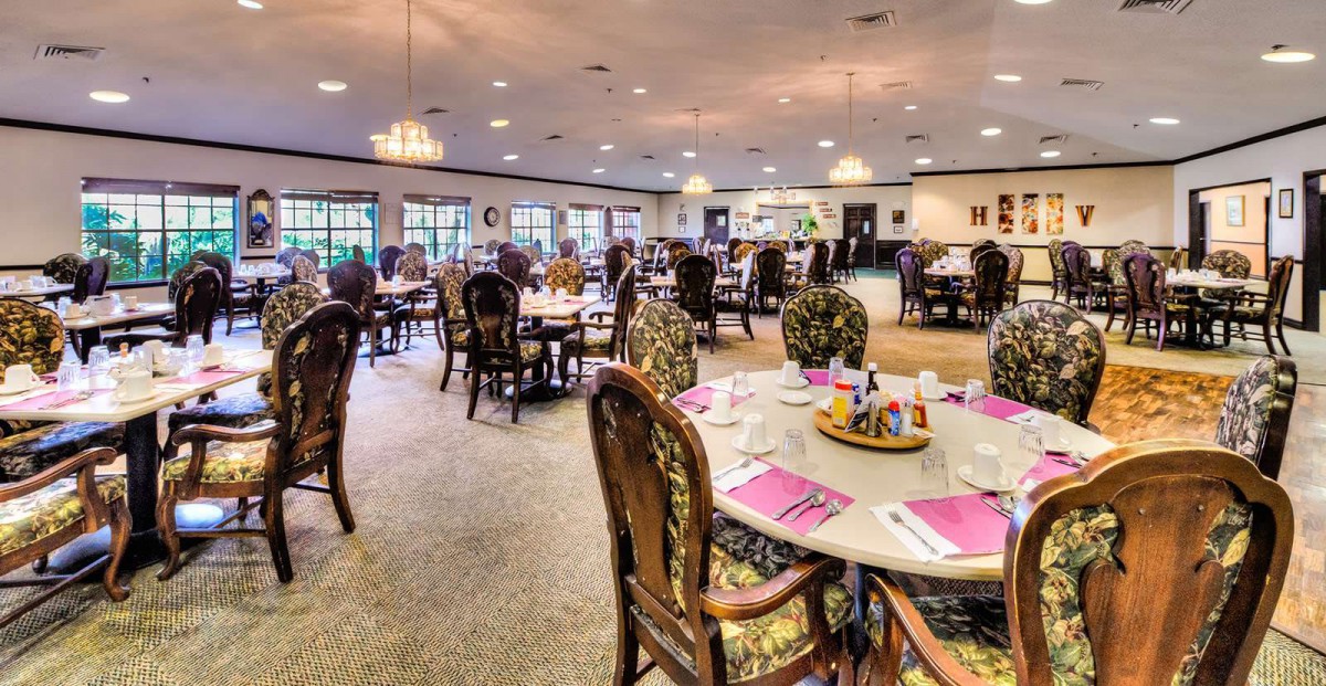 A well-decorated dining area with neatly arranged tables and chairs, set for guests.