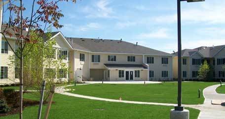 A suburban residential building with a well-maintained lawn.
