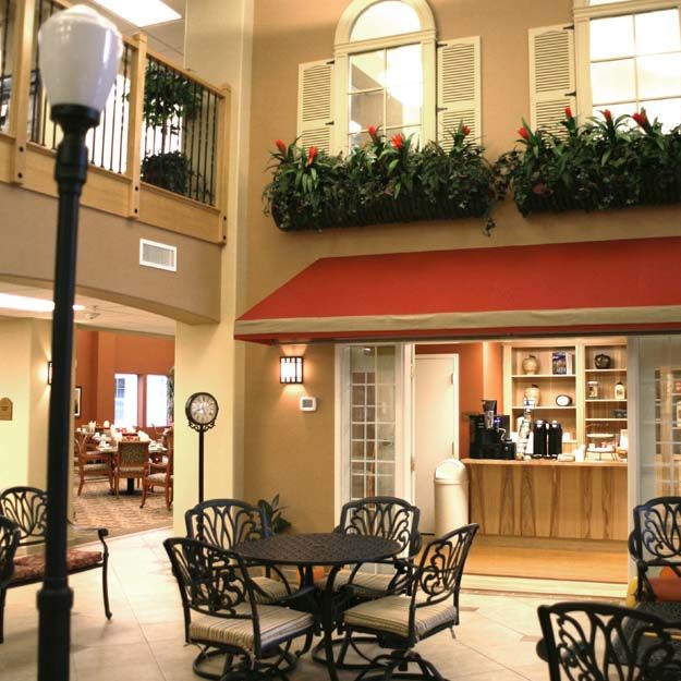 A cozy indoor cafe setting with a lamppost and elegant seating arrangements.