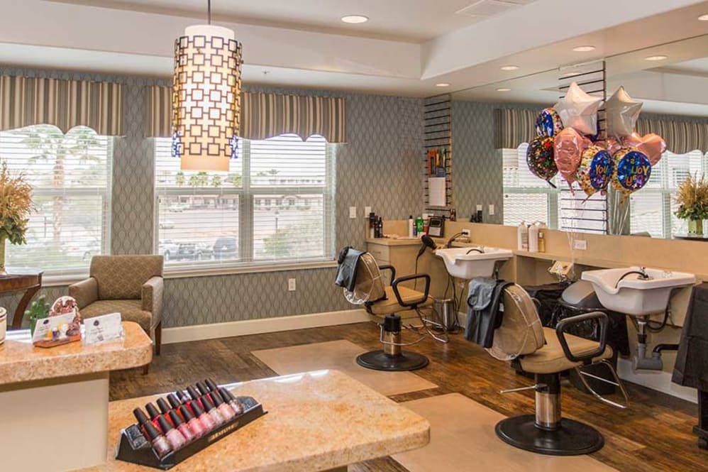 A modern interior of a nail salon with manicure stations and stylish decor.