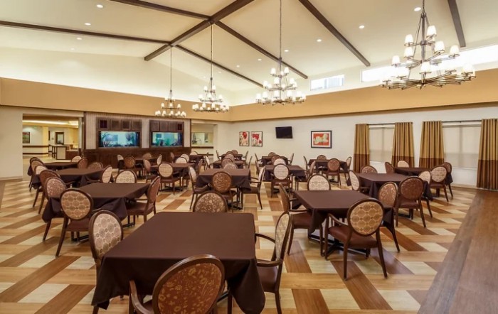 Spacious dining area with elegant tables and chandeliers.