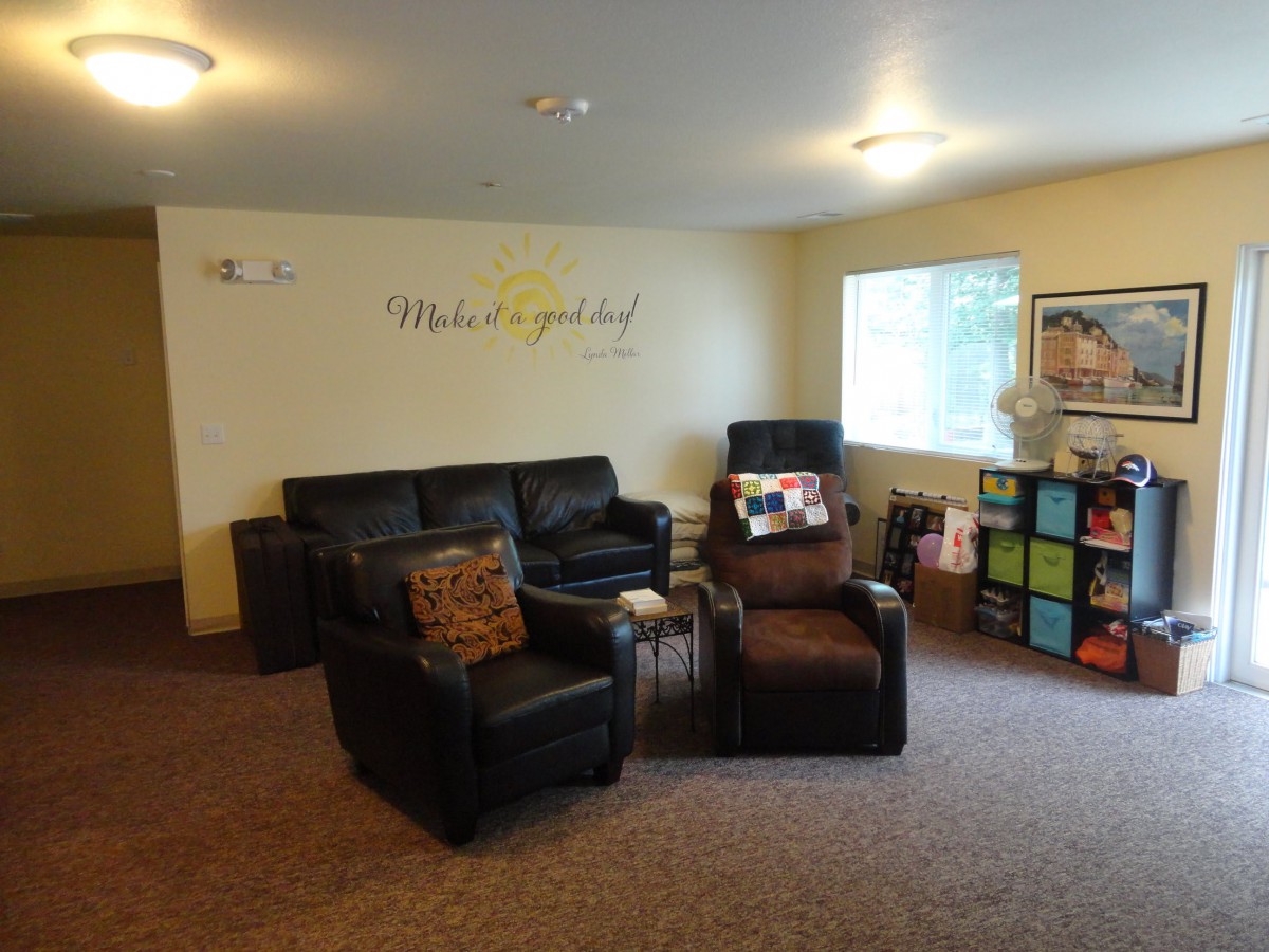 A cozy living room with comfortable seating and decorative elements.