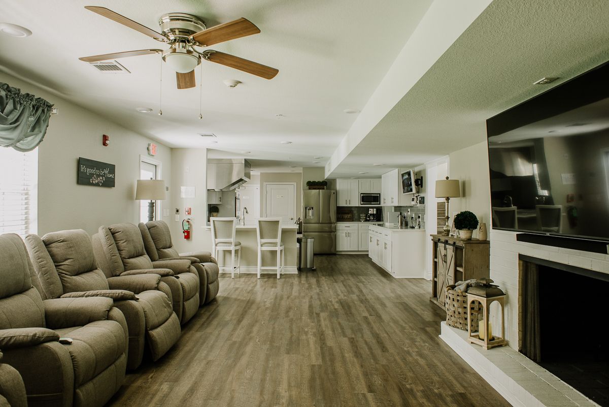 A modern open-concept living space with a kitchen and comfortable seating.