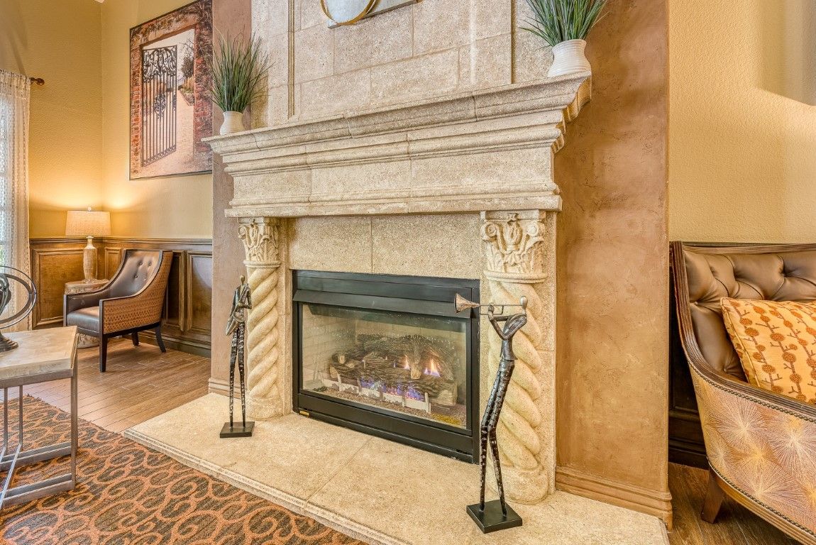 A luxurious traditional fireplace with decorative pillars and a cozy ambiance.