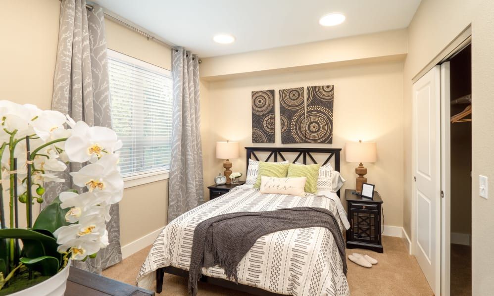 A modern and cozy bedroom decorated with stylish artwork and soft lighting.