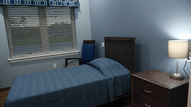 A simple bedroom with a single bed, a chair by the window, and a dresser.