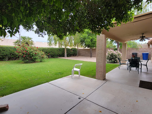 A serene outdoor space featuring a well-maintained garden and patio area.