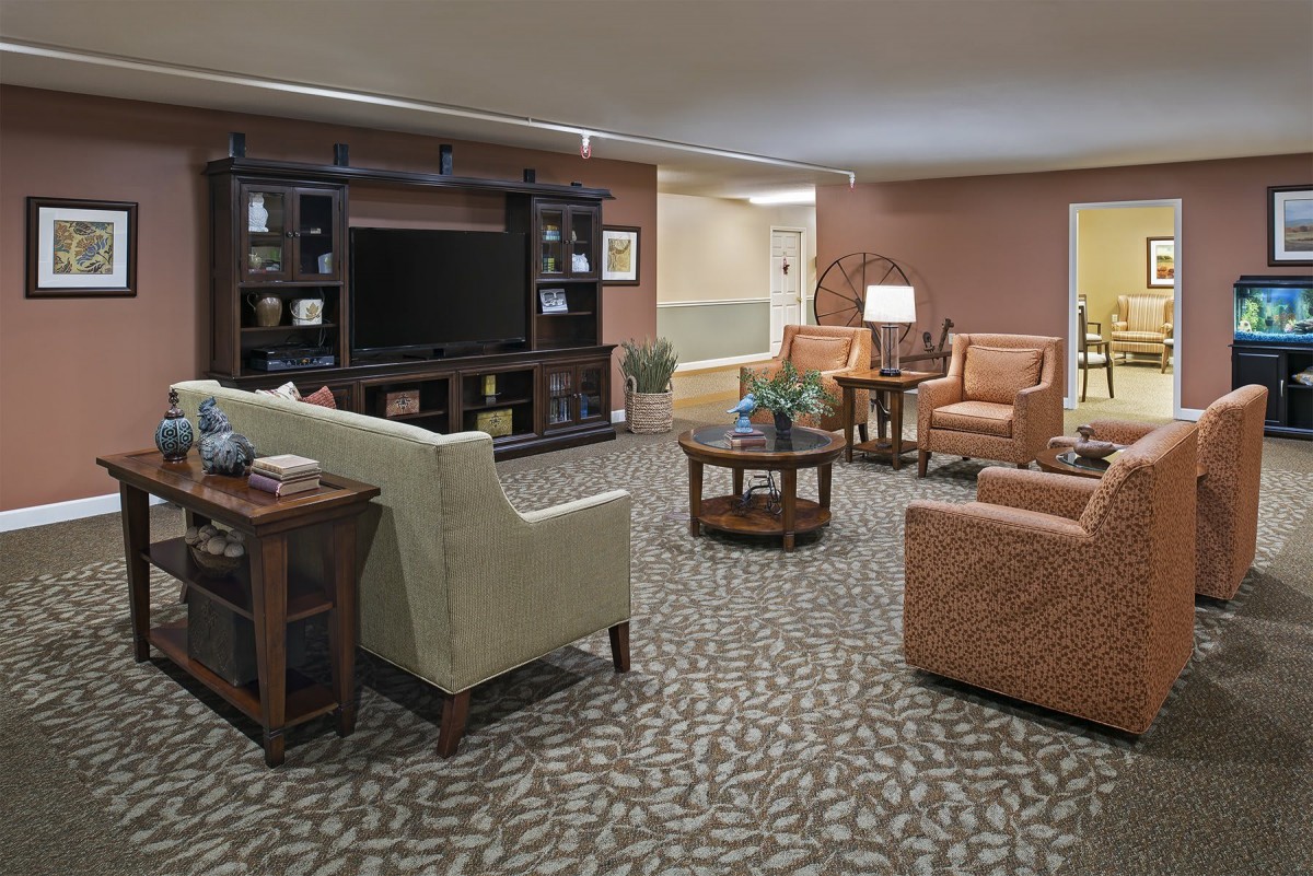 A cozy living room with a seating area and television.