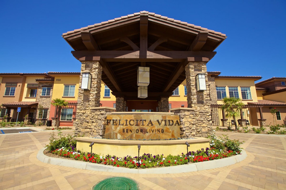 Entrance to Felicita Vida, featuring stonework and modern architectural elements.