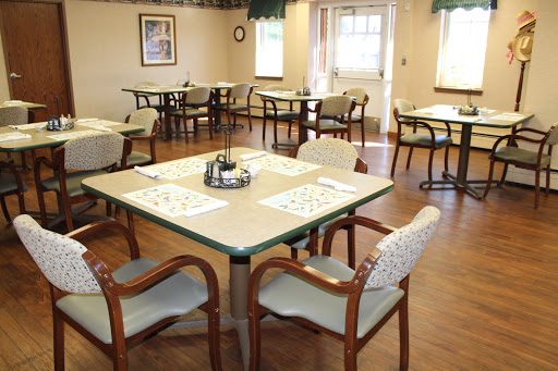 A spacious and well-lit dining area with neatly arranged tables and chairs, ready for guests.