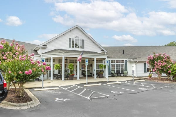 A quaint residential building with a parking lot and handicap spaces.