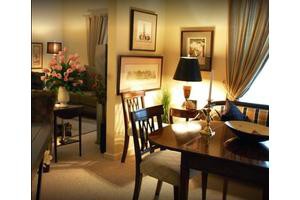 A cozy dining room with warm lighting, featuring elegant furniture and artwork.