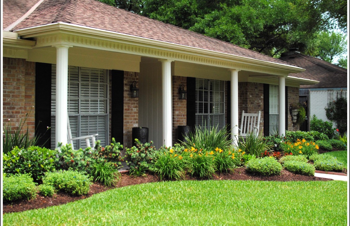 A cozy house with a landscaped garden and a welcoming front porch.