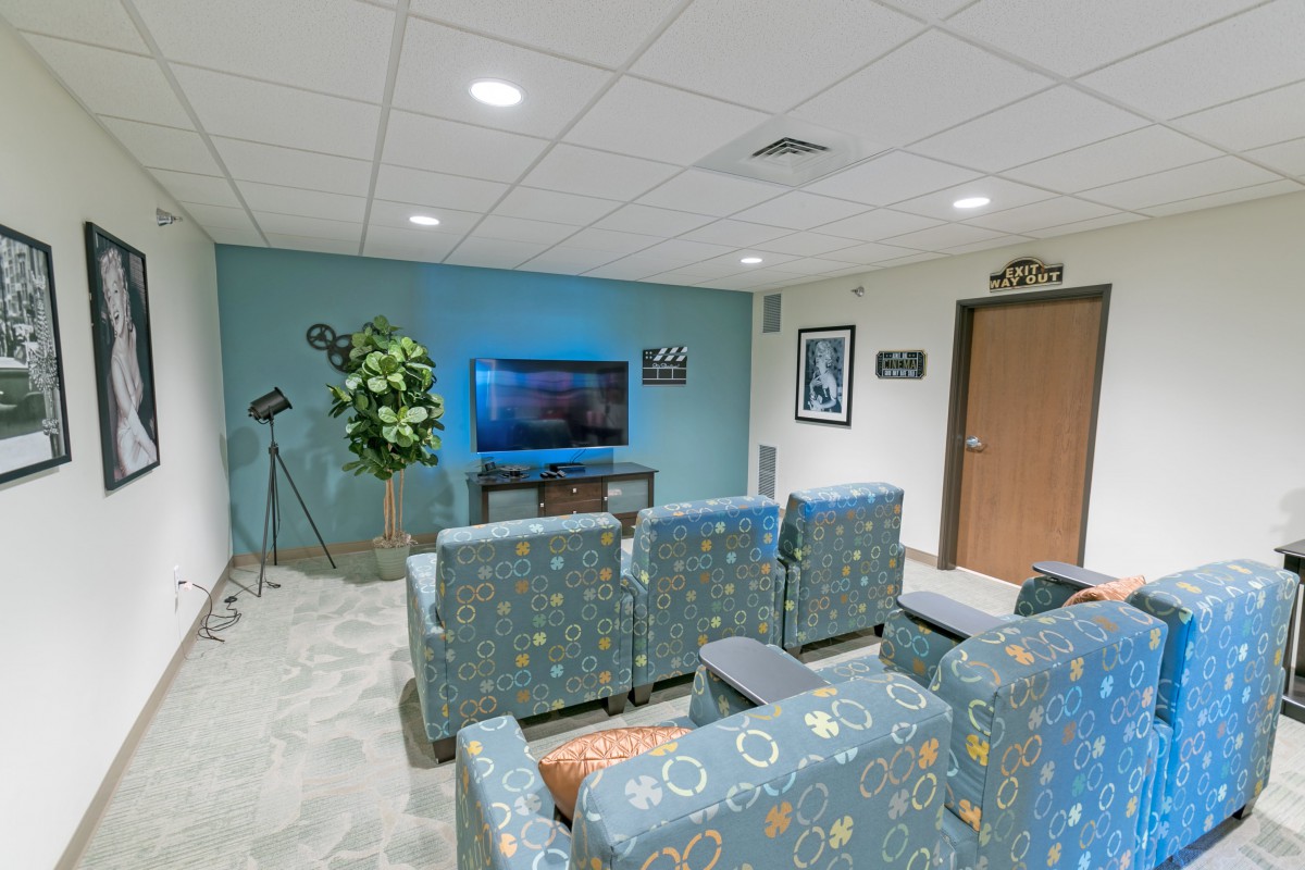 A modern lounge area with a television and comfortable seating.