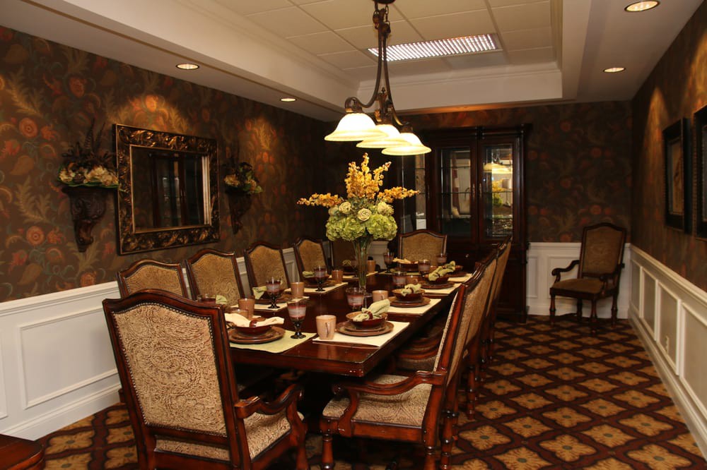 An elegantly decorated dining room set for a formal dinner.