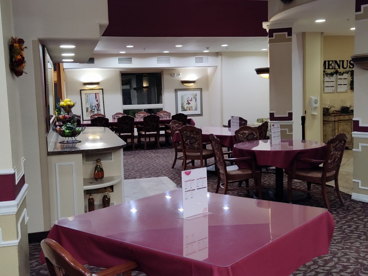 An empty dining area with neatly arranged tables and chairs.