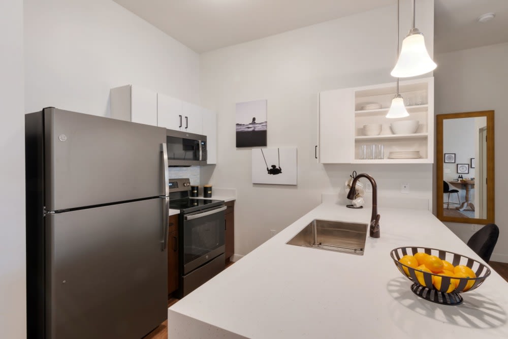 A modern kitchen with stainless steel appliances and a sleek countertop.