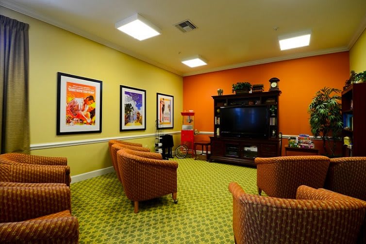 A cozy media room with comfortable seating and a large entertainment center.