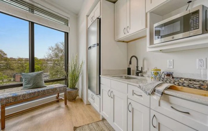 A modern, cozy kitchen with natural light and a window seat.