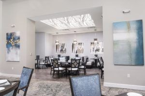 A modern dining room with elegant furnishings and a skylight.