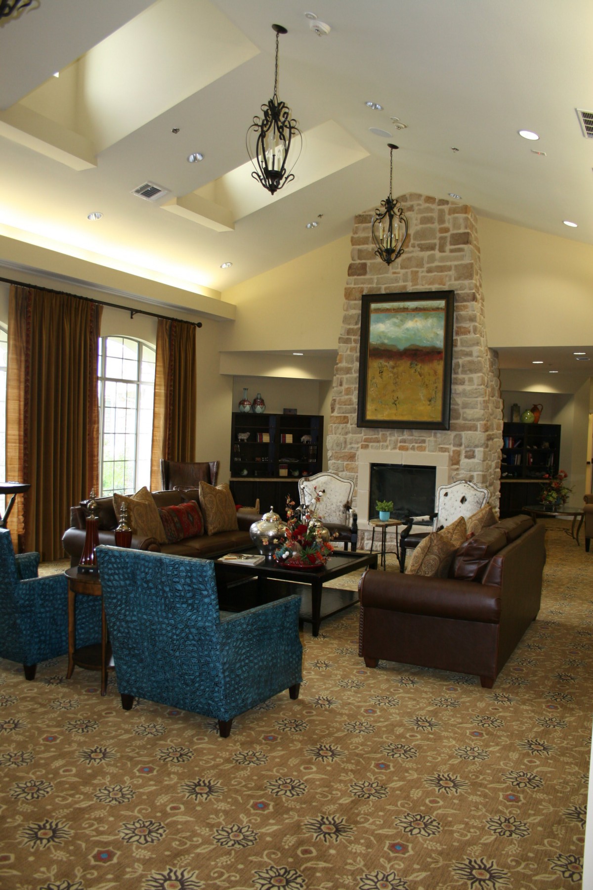 A cozy living room with a fireplace, sofas, and elegant decor.