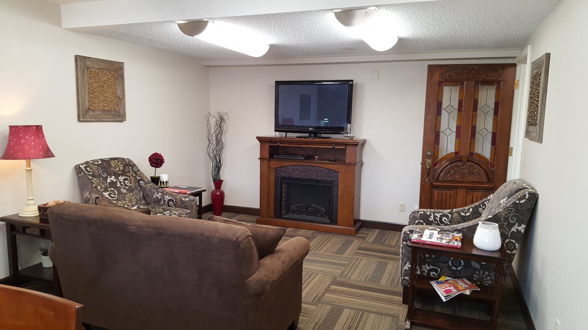 A cozy living room with a fireplace and TV.