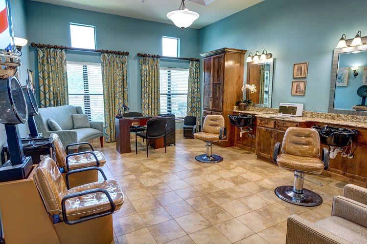 A cozy salon interior featuring seating, mirrors, and stylish decor.