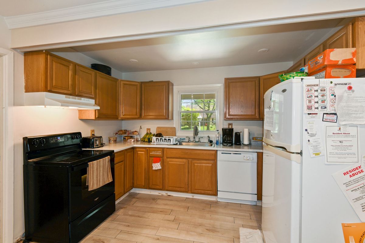 A cozy kitchen with wooden cabinets and modern appliances.