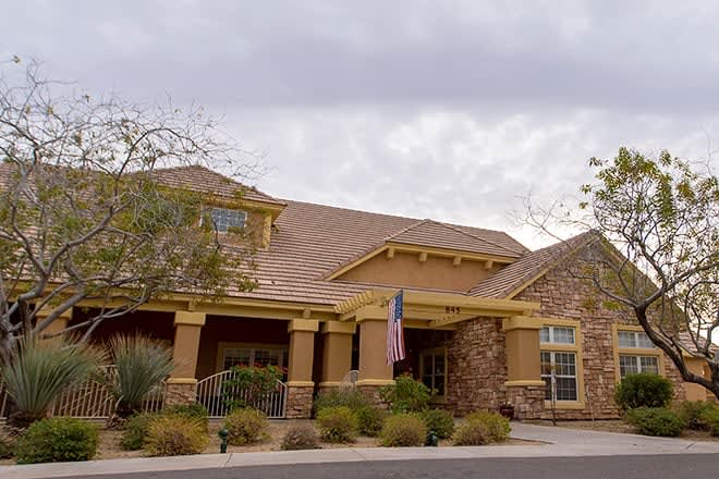 A suburban residential house with a stone facade and well-maintained landscaping.